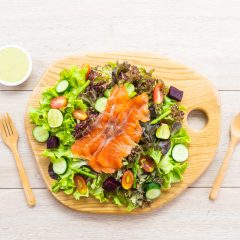 Raw Smoked salmon meat fish with fresh green vegetable salad and sauce - Healthy food concept