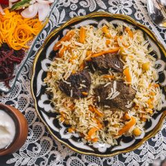 top view of rice with carrot cooked with lamb served with yogurt and salad